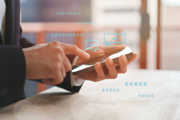 istock Live chat chatting and social media marketing technology concepts, Businessman hands using mobile smartphone with chat box icons. 1959564513