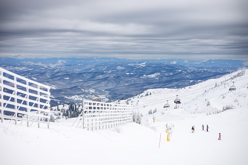 View of base village of Colorado, USA, ski resort on nice winter day; mountains and blue sky in background