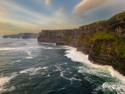 The Cliffs of Moher are located in County Clare, Ireland, along the country's western coast. They are one of the most famous natural attractions in Ireland, offering stunning views of the Atlantic Ocean. The cliffs rise to a height of about 702 feet (214 meters) at their highest point and stretch for approximately 5 miles (8 kilometers) along the coast.