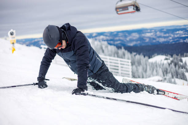 istock Resilient man rising after ski fall 1959584432