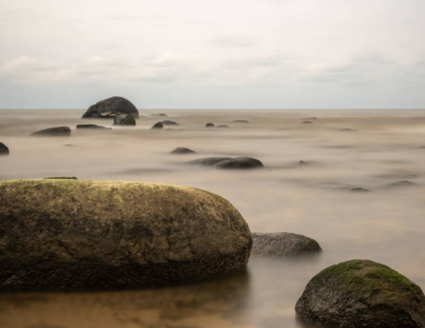 istock Mystic Shores: Long Exposure Captures Stones Enveloped by the Sea's Dark, Otherworldly Aura 1959596968