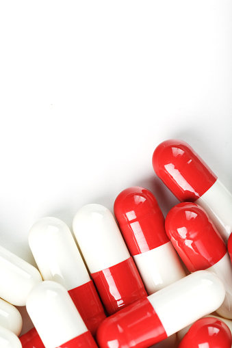 Red and white tablets on a white background with free space. Top view