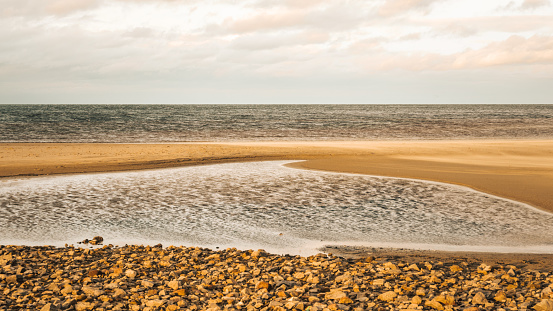 As the sun bids adieu, the beach becomes a canvas, painted in hues of sunset dreams. Golden hour.