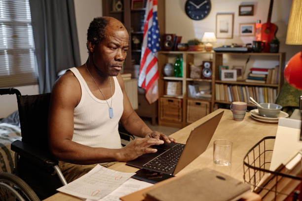 istock Mature Black Man Looking Through Information on Portable Computer at Home 1959606666