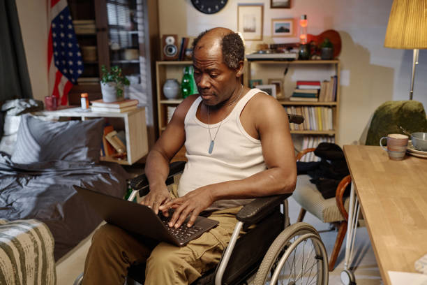istock Retired Man with Physical Disability Browsing His Laptop 1959607759