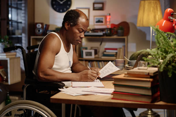 istock African American Man with Disability Writing in His Notebook 1959608301