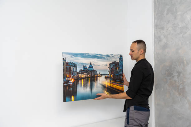 istock repairman master holds a photo canvas 1959618670