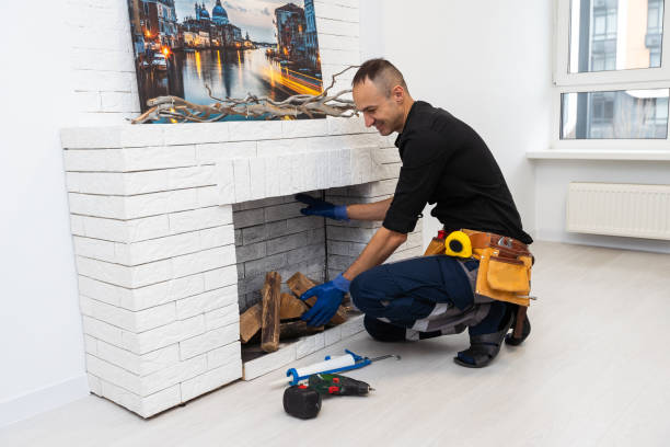 istock Service technician repairing a fireplace in a home 1959626650