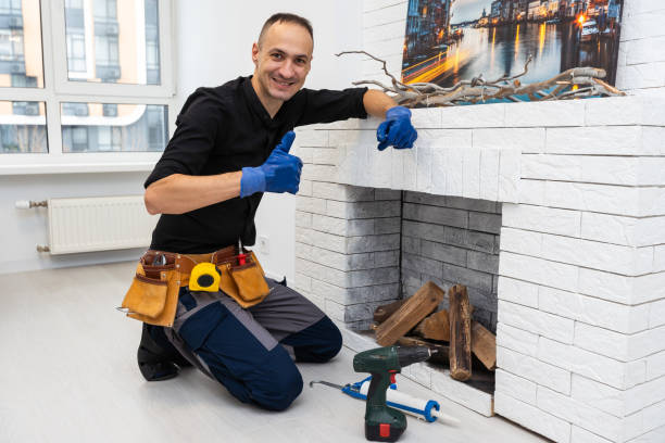 istock Worker building brick stove or fireplace checking it with spirit level 1959627699