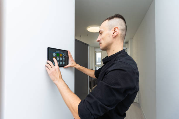 istock automation, internet of things and technology concept - man looking at tablet pc computer at smart home 1959639303
