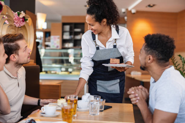 istock Hispanic Waitress Serving A Diverse Group Of Friends In A Cafe 1959648864