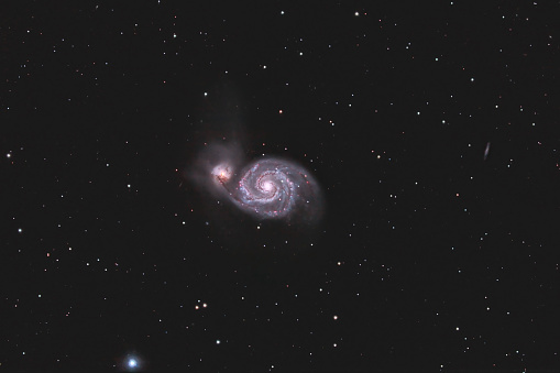 The Galaxy m 51. Spiral Galaxy. Cosmic light and cosmic dust. Photo space. Red hydrogen nebula and blue stars. Astronomical observations of space. Mysterious space.