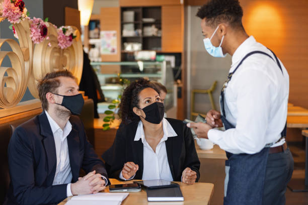 istock Mixed Race Male Barista Taking An Order In A Cafe 1959655376
