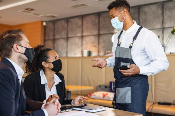 istock Mixed Race Male Barista Taking An Order In A Cafe 1959655955