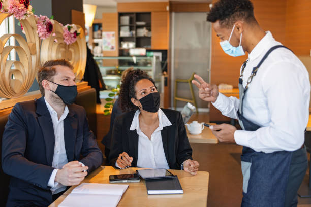istock Mixed Race Male Barista Taking An Order In A Cafe 1959655967