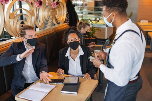 istock Mixed Race Male Barista Taking An Order In A Cafe 1959655969