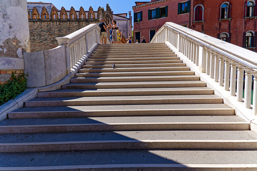 Old town of Italian City of Venice with diminishing view of stairway of Foscari Bridge on a sunny summer day. Photo taken August 7th, 2023, Venice, Italy.