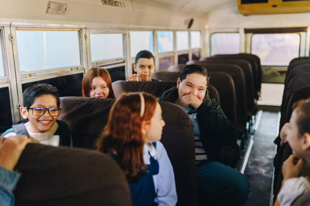 istock Friends students talking on the school bus 1959674221
