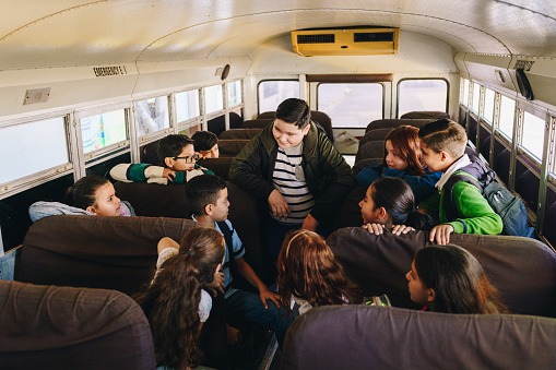 Child students talking on the school bus