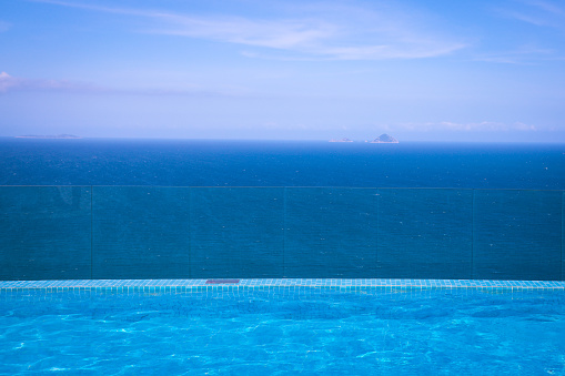 An infinity pool overlooking the sea. no people. POV
Simple image.
