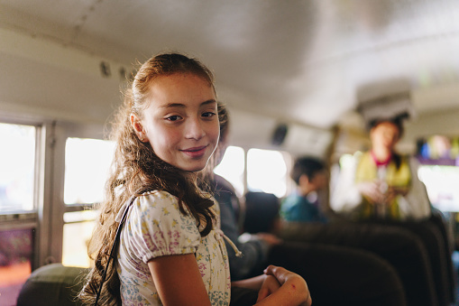 Portrait of a child girl on the school bus