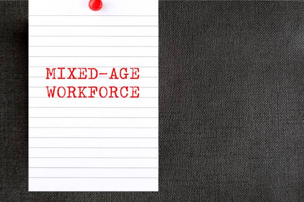istock Pinned paper on office wall with text written MIXED-AGE WORKFORCE, refers to multi-generational workplace and age diversity in the team 1959685473