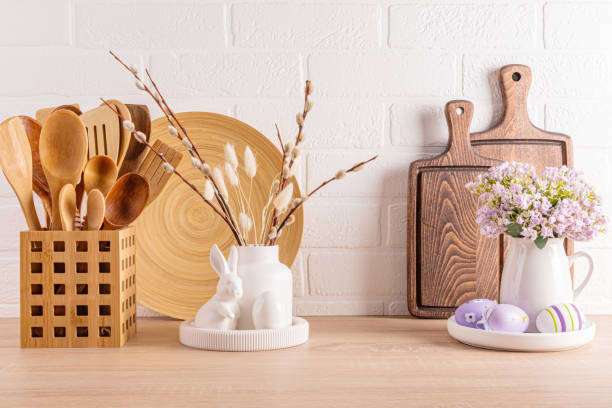 istock Stylish kitchen background for the Easter holiday. jars for bulk products, cutting boards, a vase with willow sprigs, Easter eggs and bunnies. 1959690694