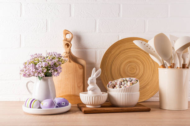 istock Easter holiday decorations on a wooden kitchen countertop with eco-friendly kitchen utensils and eggs, ceramic bunnies . Easter concept. 1959690701
