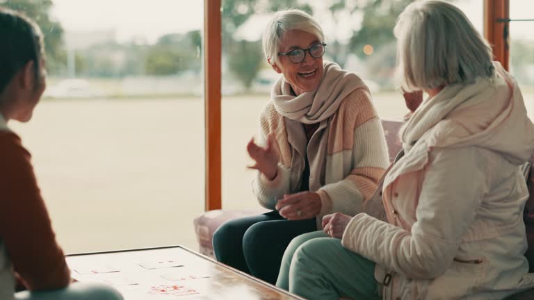 Bingo, senior friends and women excited in a retirement home with win and bonding. Elderly woman, winning and game with celebration and motivation together with group and board games in a house