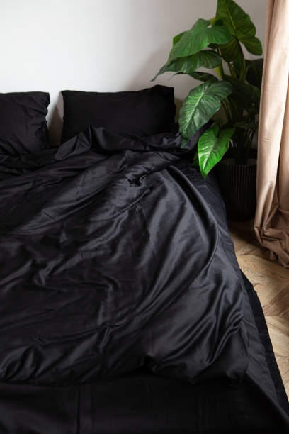 istock Texture of black crumpled bed linen on the bed 1959740801