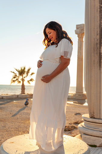 Portrait of pregnant woman in ancient city