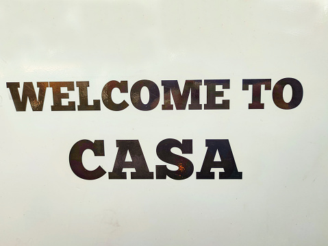 Store front sign saying welcome to Casa at street of glasgow scotland england UK