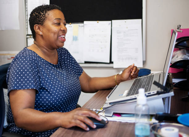 istock Smiling hospital administrator working on laptop in her office 1959755446