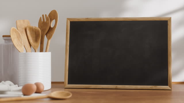 Chalkboard in wood frame on the kitchen table, looping mockup
