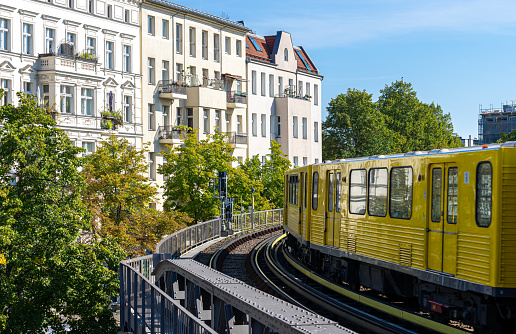 Germany, Berlin, September 25, 2023 - Berlin U-Bahn train against residential buildings in the city, Berlin Kreuzberg