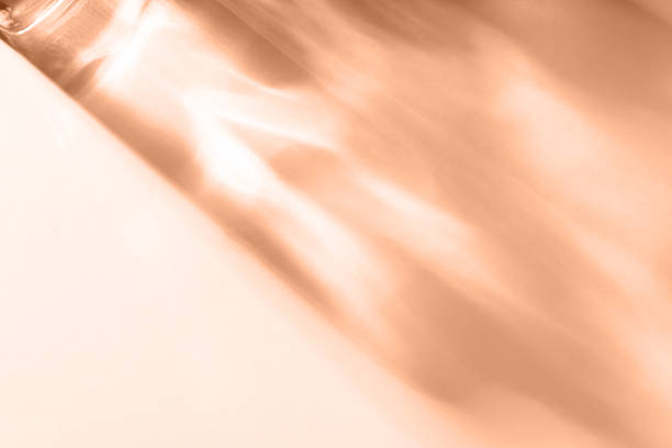 istock Abstract shadow sun glare from glass, empty background composition for product presentation. Beautiful trendy peach color color background 1959782904