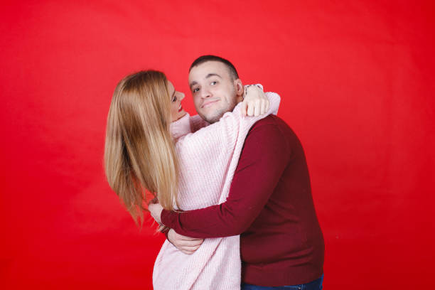 istock Young man hugging with his girlfriend and smiling at camera 1959808694