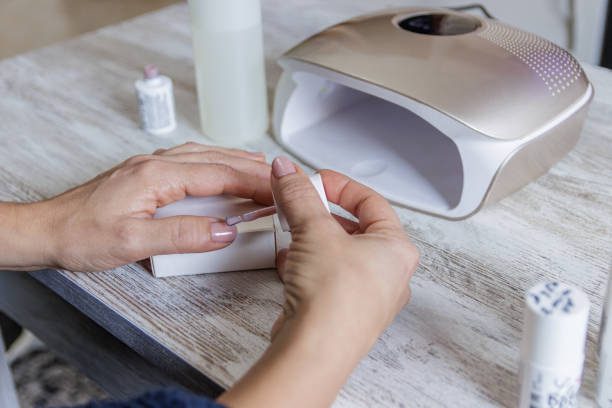 istock Painting nails with permanent paint and drying machine 1959817322