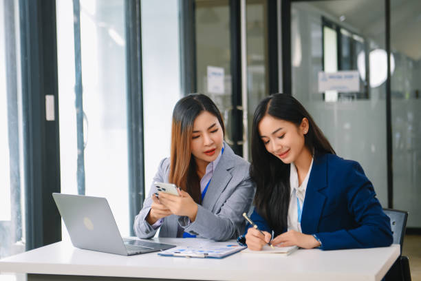 istock Asian business colleague business presents and explains and using laptop and tablet. Teamwork, financial marketing team, 1959833227