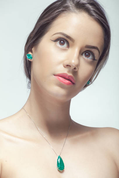 Extreme close-up showing the eye, cheek, and earring of a woman with flawless skin and elegant makeup. High quality fashion and beauty detail image for luxury and cosmetic use.