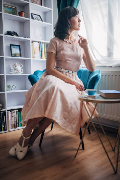 Classy young woman sitting in her modern apartment.