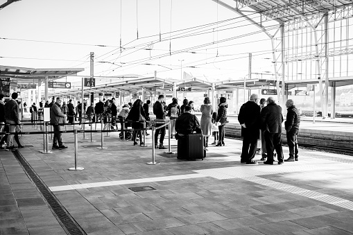 Santiago de Compostela, Spain - December 30, 2019: Passengers on the platform of the city's railway station, waiting for their train.