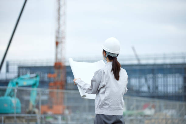 Japanese woman wearing work clothes working at a construction site