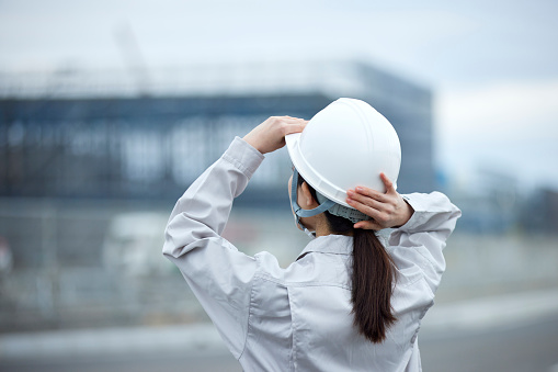 Japanese woman wearing work clothes working at a construction site