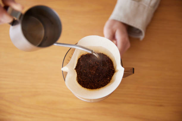 istock A woman's hand pouring coffee 1959872870