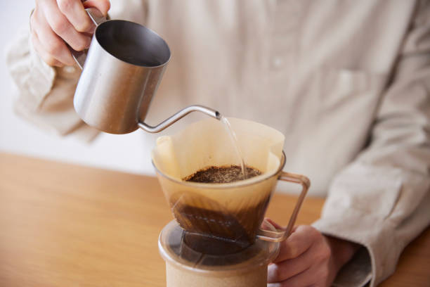 istock A woman's hand pouring coffee 1959872872