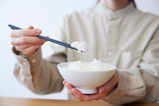 Hands of a woman eating rice