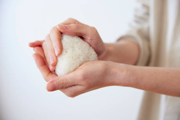 istock Hands of a woman making rice balls 1959873976