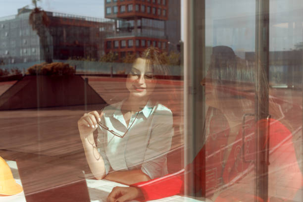 istock Two young women, an engineer and an architect, are working together on a construction project in a bright and modern architecture and engineering company office 1959914038