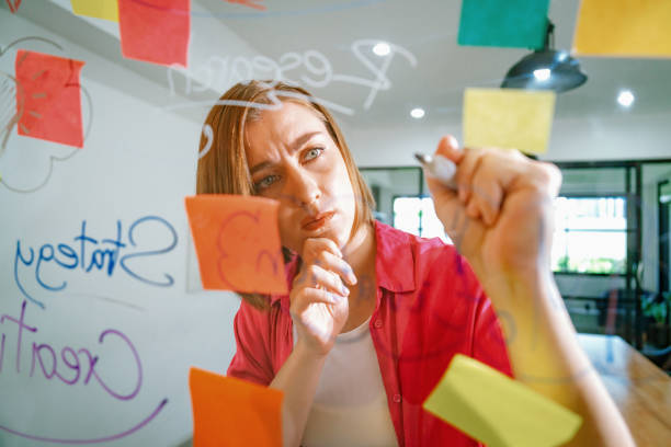 istock Young beautiful business leader writing marketing idea on board. Immaculate. 1959920383